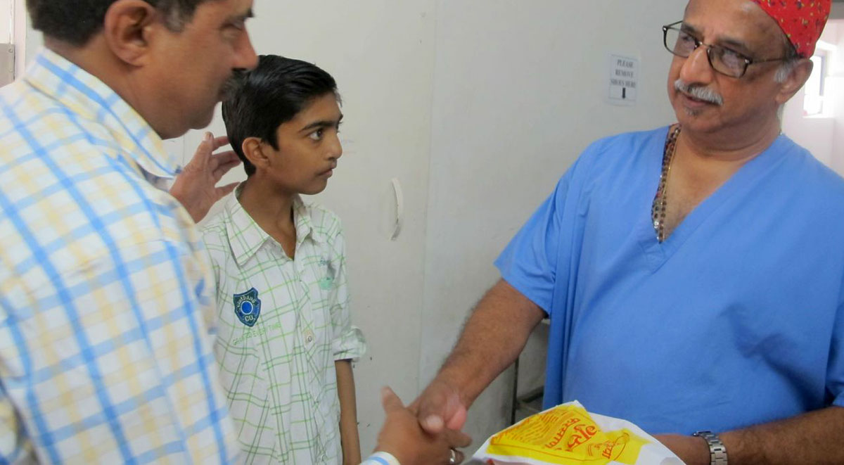 Ashiket presenting sweets to Dr George Teturswamy